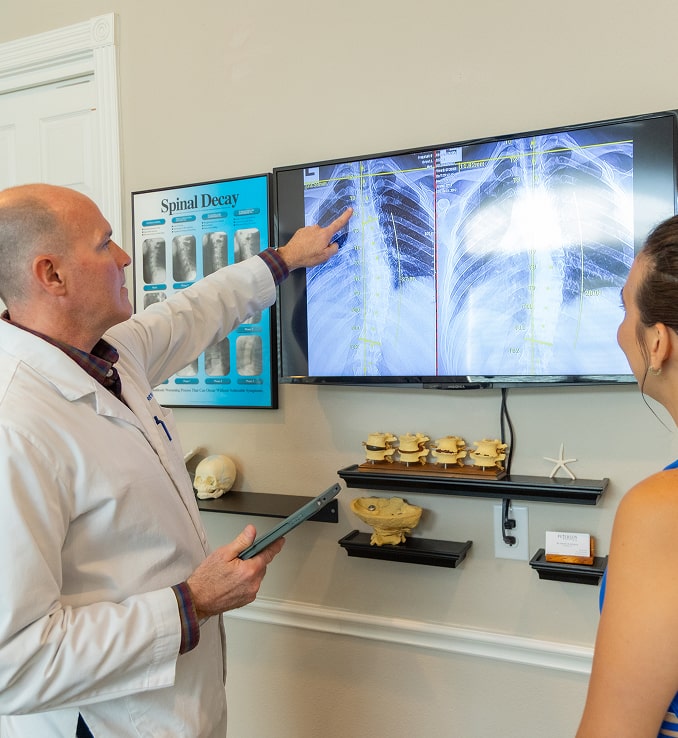 Reviewing spinal X-rays with a patient at Chiropractic Care Clinic